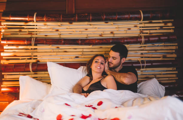 Man and young woman celebrate in rural house room.