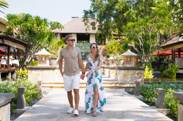 Romantic couple walking in tropical resort. Concept of luxury lifestyle.